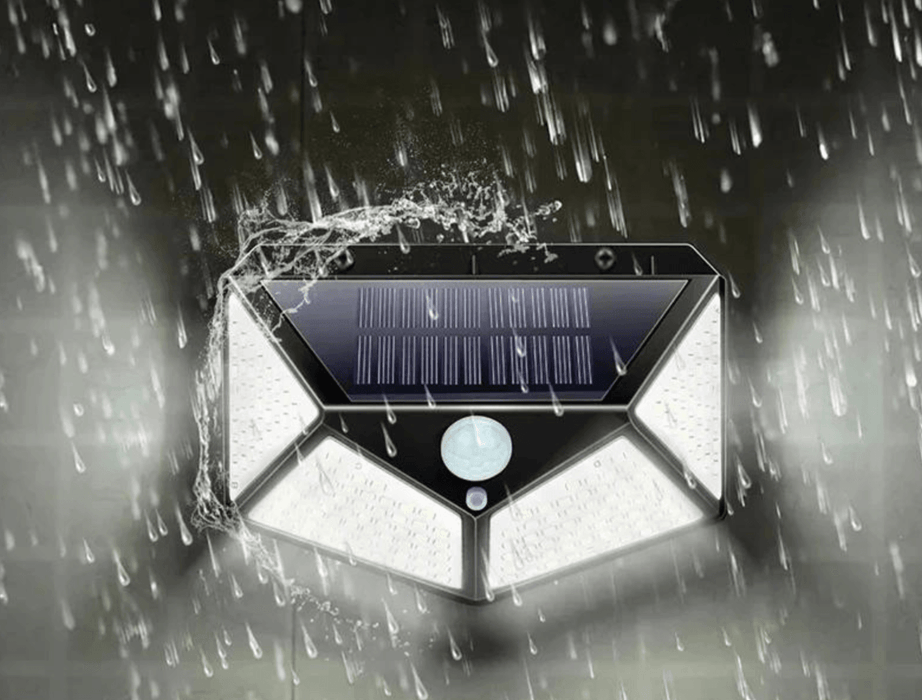 The solar-powered motion sensor light depicted in heavy rain. The light is shown to be waterproof and functioning well under harsh weather conditions, with water splashing off its surface.