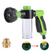 A green hose nozzle with a clear soap dispenser attached, along with a shower adapter fitting shown separately.