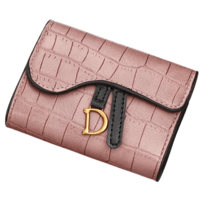 A close-up of a pink crocodile-pattern wallet with a gold "D" buckle, isolated on a white background.