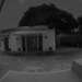 Black and white image from a Reolink camera showing a building at night.