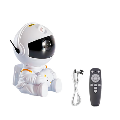 White astronaut figure sitting and holding a plush star, with a projector inside the helmet, paired with a USB cable and a remote control on a white background. The robot is characterized by its clean white and yellow color scheme and a soft, friendly design, suitable for a light and modern décor.