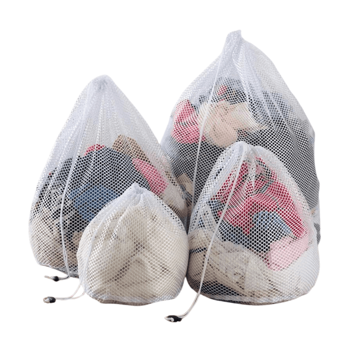 Four assorted mesh laundry bags filled with colorful clothes, providing a solution for sorting and washing different types of garments separately to maintain fabric quality.