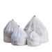 Set of four different sized white mesh laundry bags on a neutral background, designed for sorting and protecting various garments during washing.