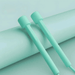 A close-up view of two turquoise jump rope handles resting on a matching colored background, emphasizing their sleek and simple design.