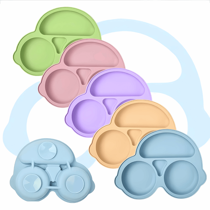 Stacked assortment of silicone baby plates in pastel shades of green, pink, purple, beige, and blue, each designed with multiple compartments. These plates are shaped like vehicles, enhancing the visual appeal and functionality for children's meals.