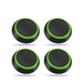 A set of four black thumb grips with green edges, designed for gaming controllers.