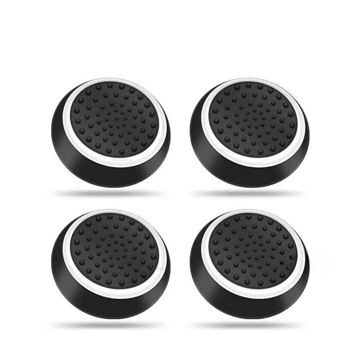 A set of four black thumb grips with white edges, designed for gaming controllers.