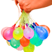 A hand holding a cluster of brightly colored water balloons filled and ready to burst, with colors like pink, yellow, green, and blue vividly displayed. Water is dripping from the balloons as they are being held up.