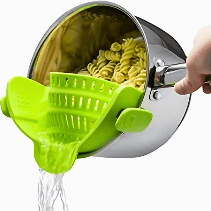 A person pours water from a pot full of pasta with a green clips that holds the pasta so it doesn't fall and allows the water to escape. Ideal for simple food preparation.