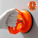 A person wearing white gloves applies an orange suction cup to a smooth wall surface; a small inset highlights the suction cup’s metal tightening mechanism.