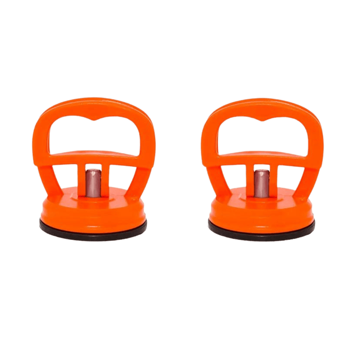 Two orange suction cup tool used for car repair, featuring a prominent handle with a hollow center for grip and a metallic central pillar connected to the black suction mechanism at the base.