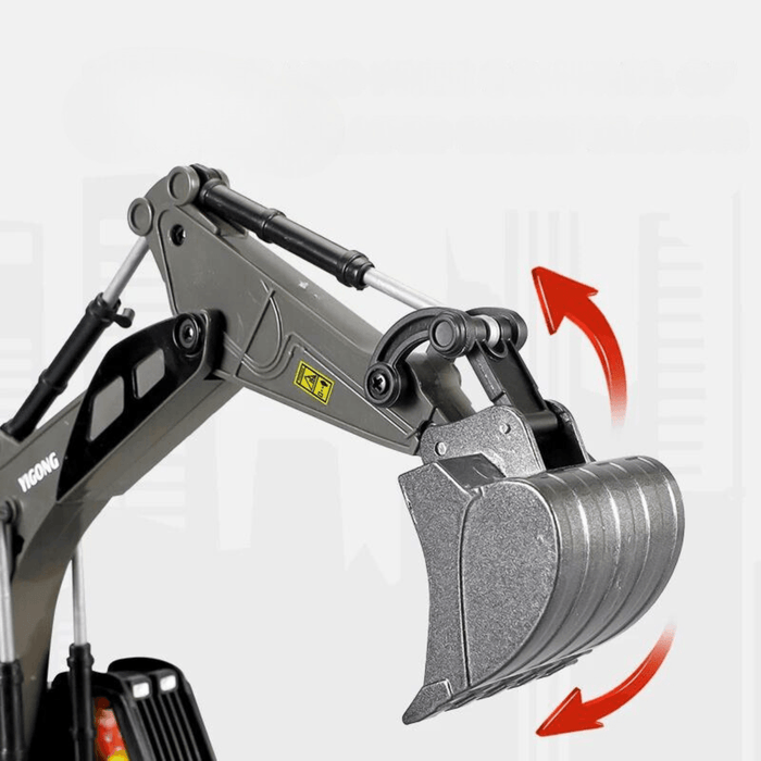 Close-up of a toy excavator arm with a rotating bucket mechanism. The excavator is grey with metal and plastic components.