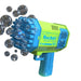 A green and blue rocket-shaped bubble gun releasing multiple bubbles. The gun has multiple nozzles and the word "Rocket" printed on the side.