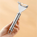 A hand holding the corn peeler, showcasing its ergonomic design and durable stainless steel construction. The peeler also has a hanging loop for convenient storage.