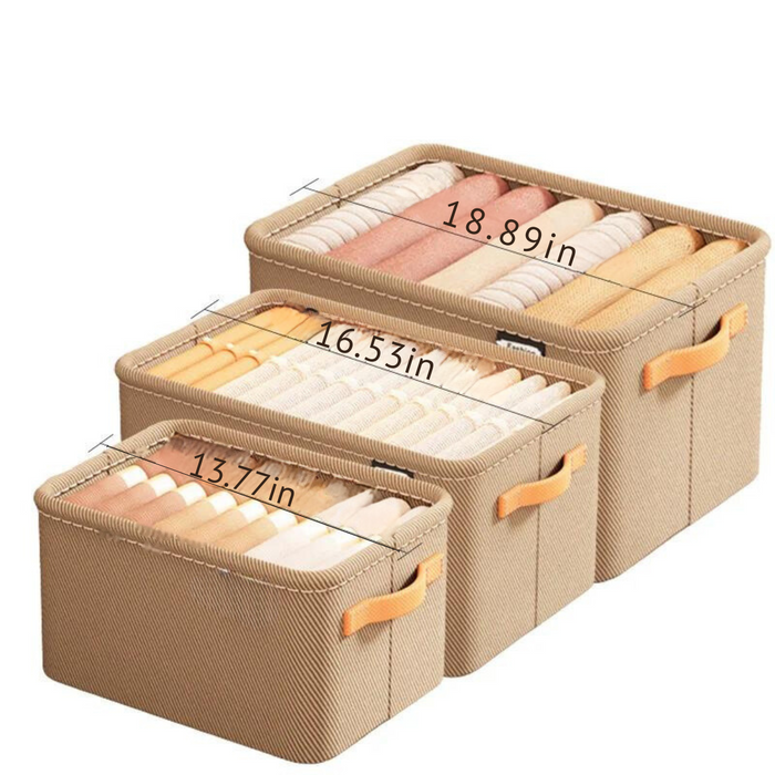 A set of three beige fabric storage bins with orange handles, each containing neatly rolled clothes. The bins are labeled with their dimensions: 18.90 inches, 16.54 inches, and 13.78 inches. The bins are arranged side by side, showing the different sizes available.