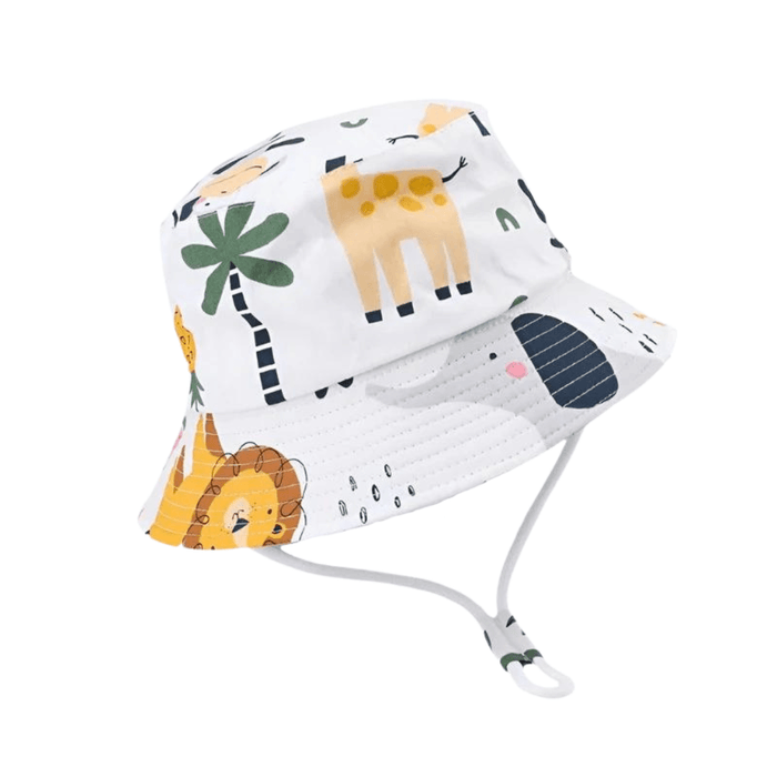 A white bucket hat with colorful animal prints, including giraffes, lions, and trees, and an adjustable chin strap.