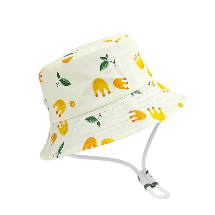 A light-colored bucket hat with yellow crowns and green leaf prints, equipped with an adjustable chin strap.