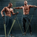 Two muscular men with short dark hair using resistance bands in an industrial gym setting, shirtless and wearing camo pants.