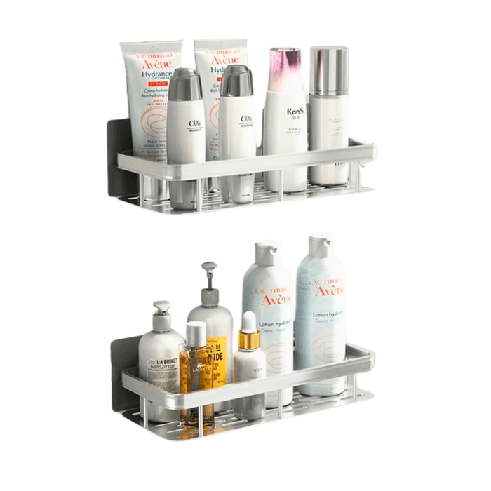 Two silver rectangular wall-mounted shelves, each loaded with various white and silver bottles and toiletries. The background of the image is white.