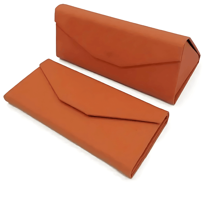 two orange eyeglasses cases with a textured fabric exterior. One case is closed and lying flat, while the other is standing upright and open, showing the geometric design and envelope-style flap closure.