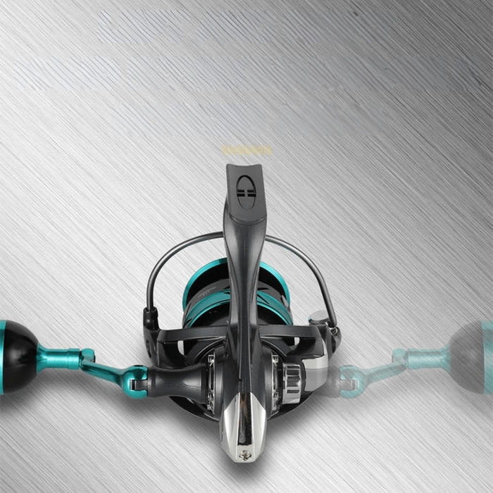 A top-down view of the fishing reel, highlighting the handle and overall design against a metallic background.