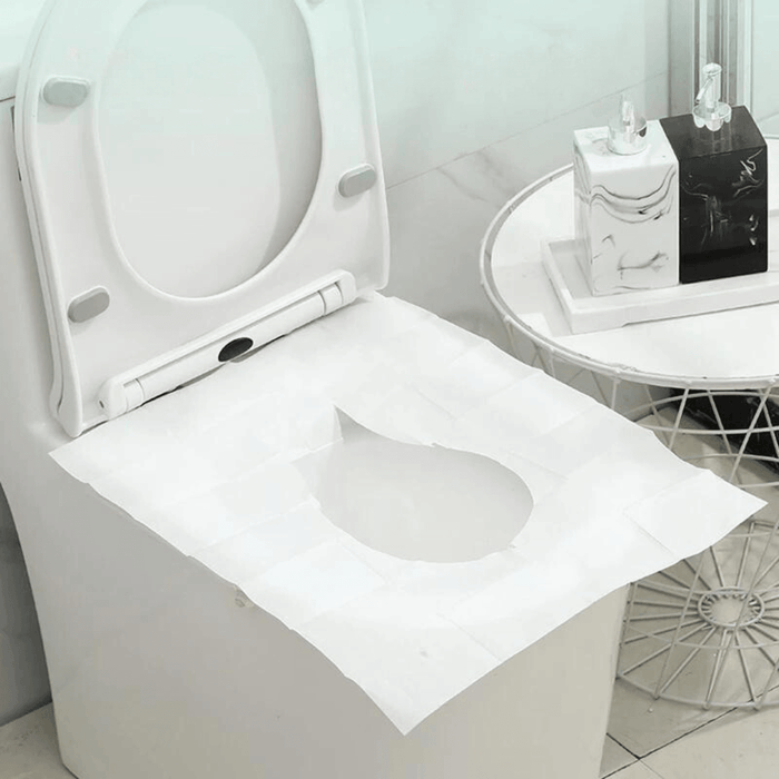 Disposable toilet seat cover neatly placed on a white toilet in a modern bathroom setting, showing the cover's perfect fit and easy application for enhanced hygiene.