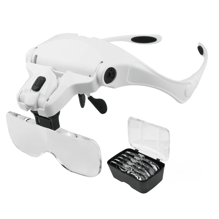 Side view of the white Illuminated Headband Magnifier Visor with a box filled with different glasses.