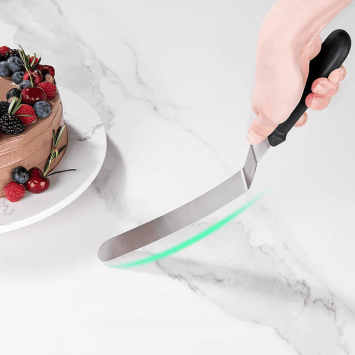 a close-up view of a spatula with a black handle and a stainless steel blade, highlighting its curved and flat edge.