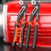 Two adjustable wrenches with black and orange handles, display on a red metal background.