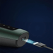 The charging port of the electric shaver is highlighted, with a USB cable being plugged into the port, showcasing the modern and convenient charging method.