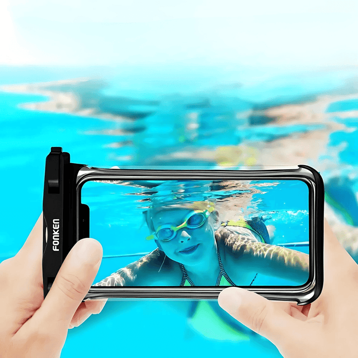 Hands holding a smartphone inside a black waterproof case, displaying a child swimming underwater. It demonstrates the case's clarity and the ability to use the phone's camera through the case under the water.