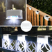 White solar stair lights illuminating fences at night.