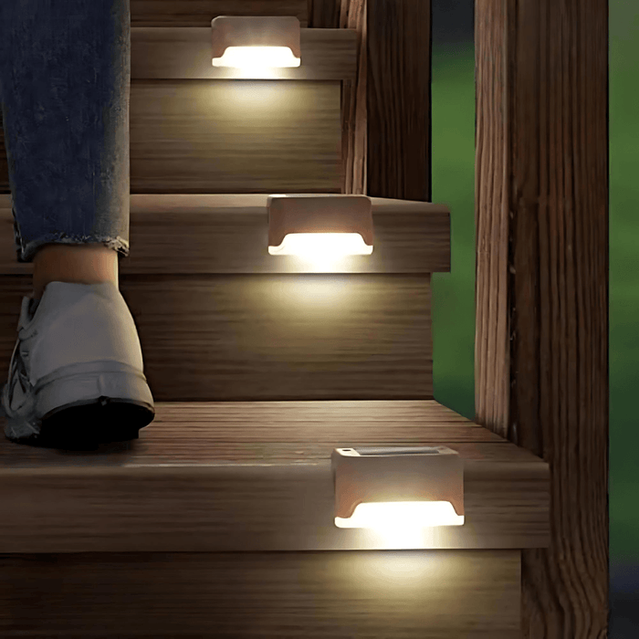 Solar stair lights illuminating outdoor wooden steps.