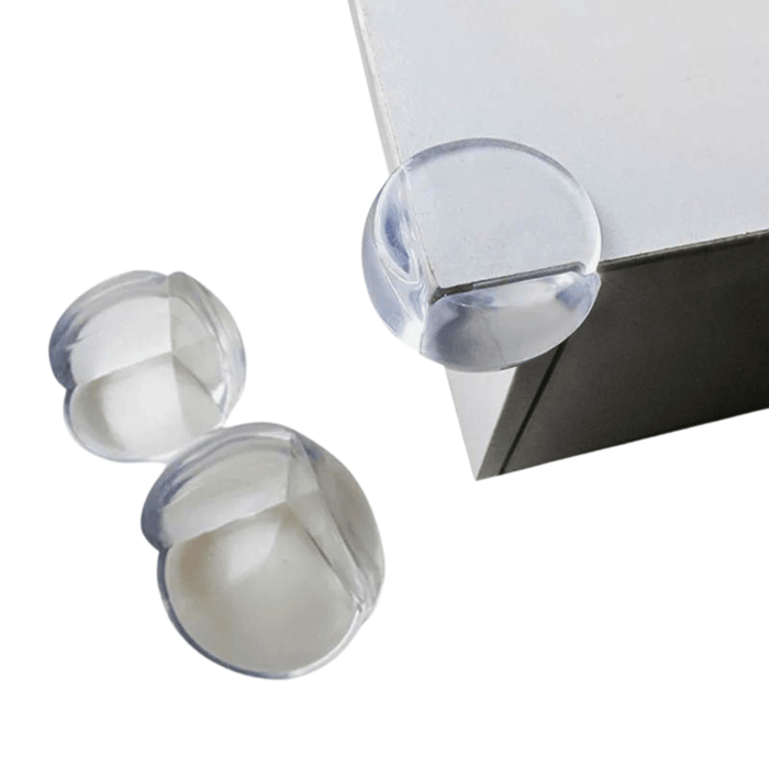 Clear corner protectors on a white table corner.