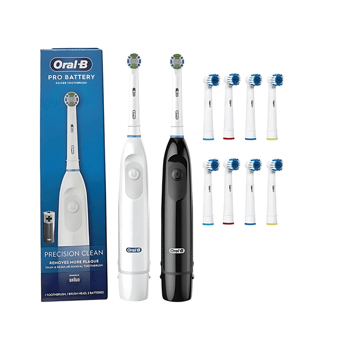 Packaging and product display of the Oral-B Pro Battery Power Toothbrush. It includes the electric toothbrush in both white and black options, surrounded by eight replacement brush heads. The product box, shown in the background, highlights its plaque removal capabilities. Display on white background.