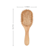 A bamboo hairbrush with an oval shape and wooden bristles, measuring 8.27 inches in length and 2.56 inches in width.