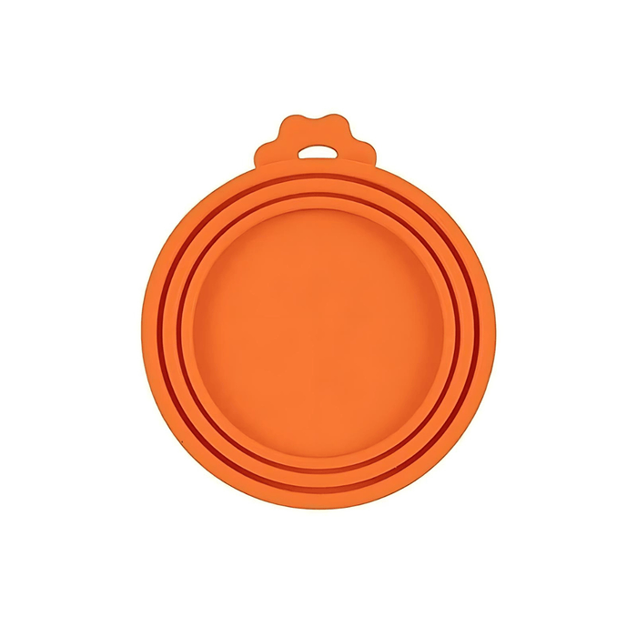 A close-up of a single orange silicone can lid. The design features multiple rings, allowing it to fit cans of different diameters, and it includes a tab for easy removal.