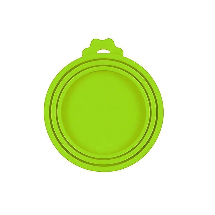 A close-up of a single green silicone can lid. The design features multiple rings, allowing it to fit cans of different diameters, and it includes a tab for easy removal.