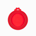 A close-up of a single  light red silicone can lid. The design features multiple rings, allowing it to fit cans of different diameters, and it includes a tab for easy removal.