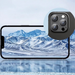 iPhone with camera lens protector and a mountain landscape background.