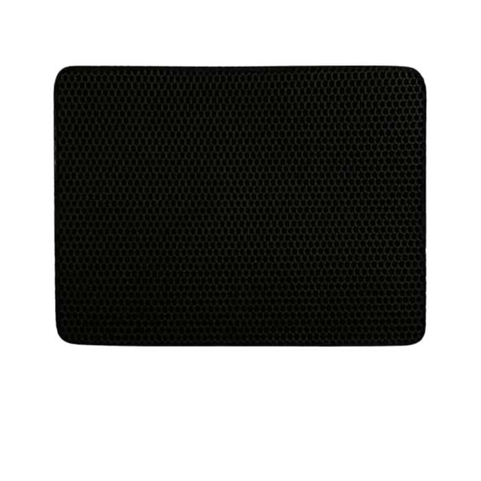 A black cat mat designed to trap sand from cat paws, helping to keep the house clean. The mat features a textured surface with numerous small holes that capture the litter as a cat steps on it after using the litter box.