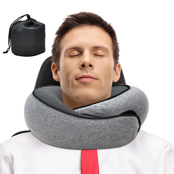 A man resting with his eyes closed, wearing a gray travel neck pillow that supports his neck. A black drawstring bag is shown next to the pillow, indicating the included storage option.