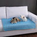 Cooling Pet Mat on Sofa with Plush Toys: The blue cooling mat is spread out on a white sofa with a small dog lying down and plush toys placed next to it. This image emphasizes the mat's versatility and suitability for various surfaces, including sofas.