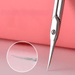 Close-up of the tip of the scissors to show the bevel and sharpness. Display on red background.