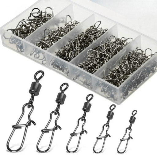 A plastic organizer box containing various sizes of fishing snap swivels, with several individual swivels displayed in front of the box to show different sizes.