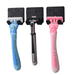 three razors with different colored handles—blue, black, and pink—each fitted with a textured black blade cover. The razors are wet, suggesting recent use or storage in a damp environment.