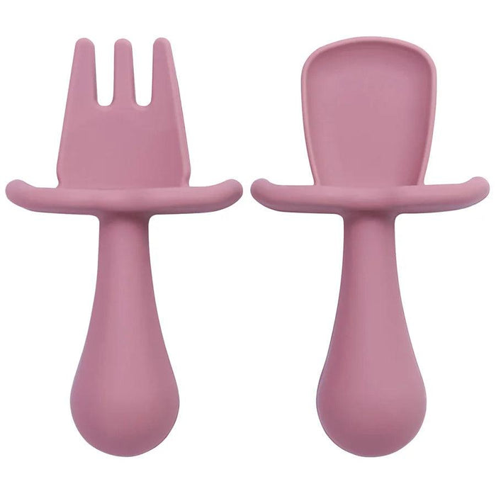 A close-up shot of two purple silicone baby utensils, a fork and a spoon, showing their detailed design and texture.