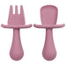 A close-up shot of two purple silicone baby utensils, a fork and a spoon, showing their detailed design and texture.