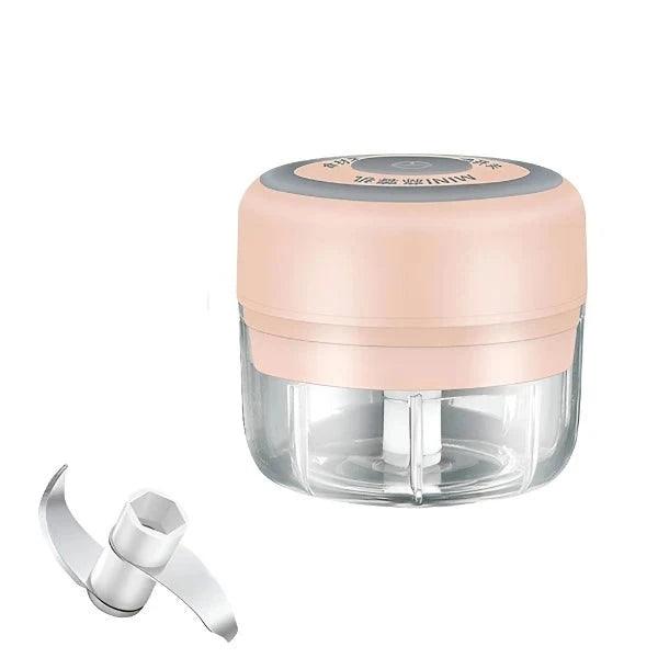 A smaller food chopper with a pink lid and blade beside it, highlighting its compact size.