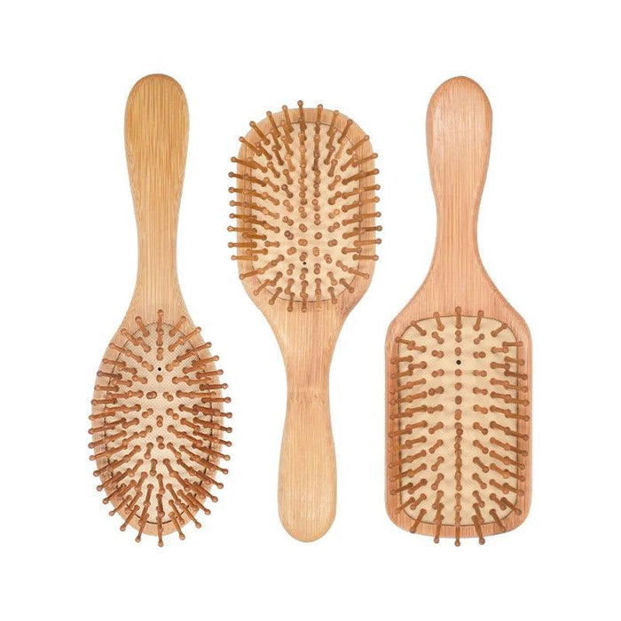 Three bamboo hairbrushes of different shapes—oval, rounded rectangular, and paddle—arranged side by side, showcasing their different designs and wooden bristles.